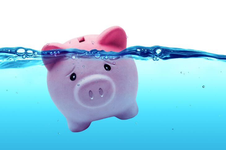 Piggy bank drowning in debt - savings to risk