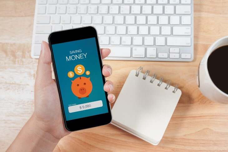 Woman hand holding the phone with saving money screen