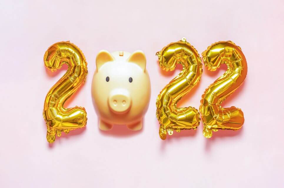 save money 2022. Happy New Year 2022. Gold 2022 balloon with piggy bank instead of 0 on pink bacHappy New Year 2022. Gold 2022 balloon with piggy bank instead of 0 on pink background.kground.